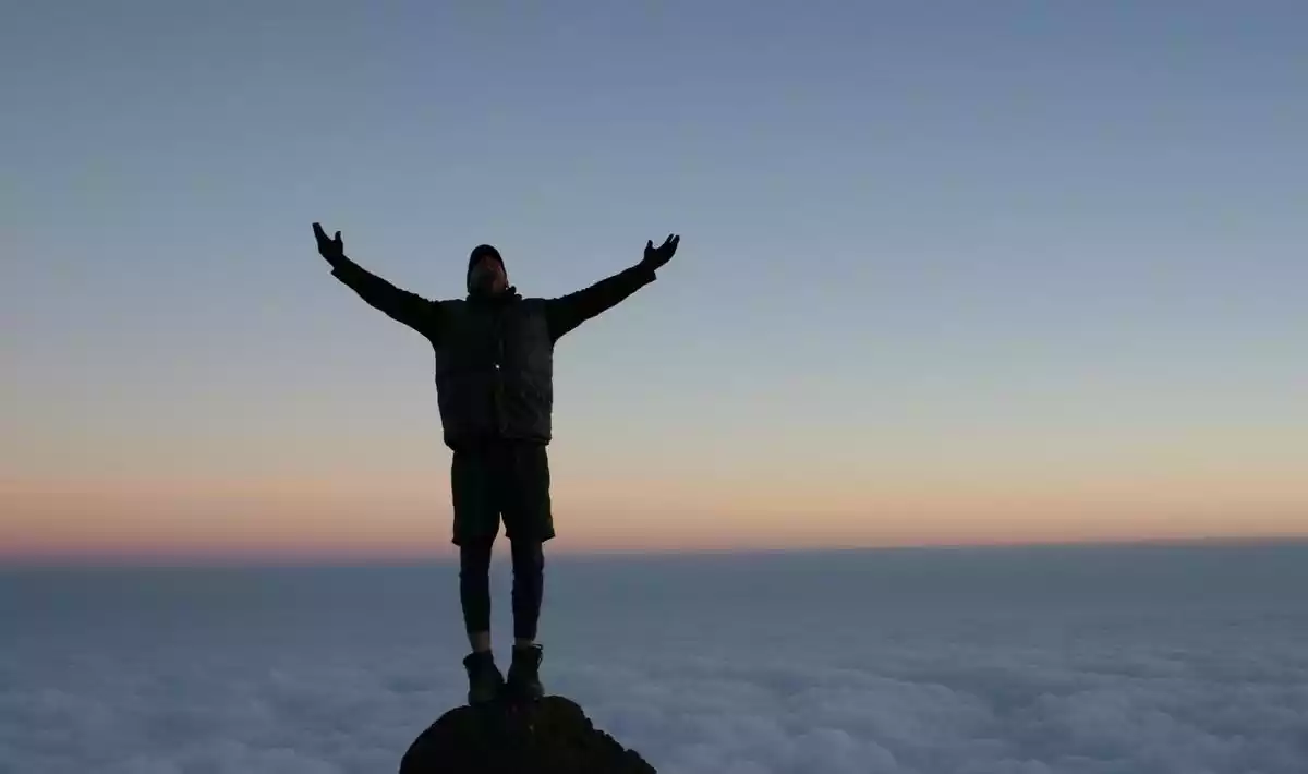 A group of climbers reaching the summit of Mount Kilimanjaro, Africa's highest peak.