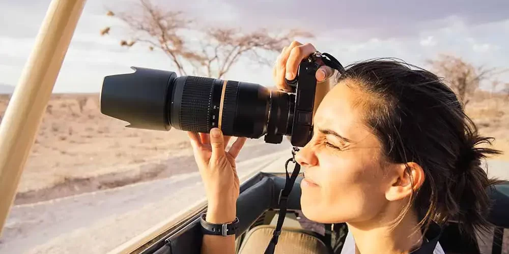 Photographers capturing stunning wildlife moments during a photography safari in Tanzania, organized by JM Tours.