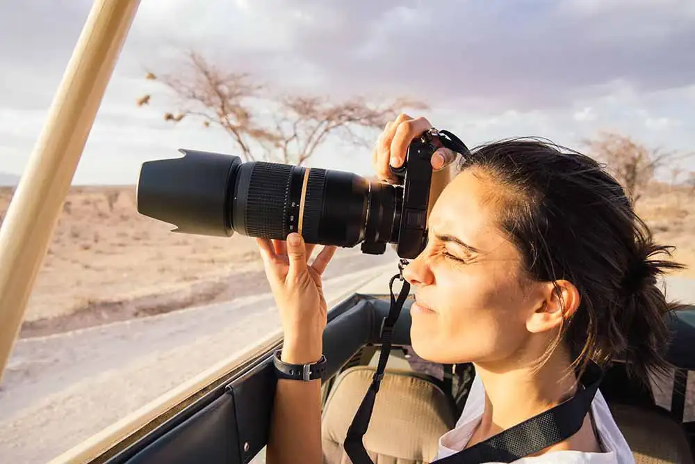 Photographers capturing stunning wildlife moments during a photography safari in Tanzania, organized by JM Tours.
