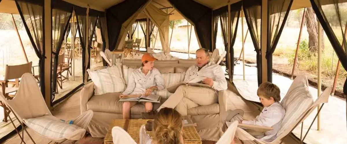 A happy family enjoying a luxury safari experience at a Serengeti lodge, arranged by JM Tours for a Tanzania Luxury Safari.