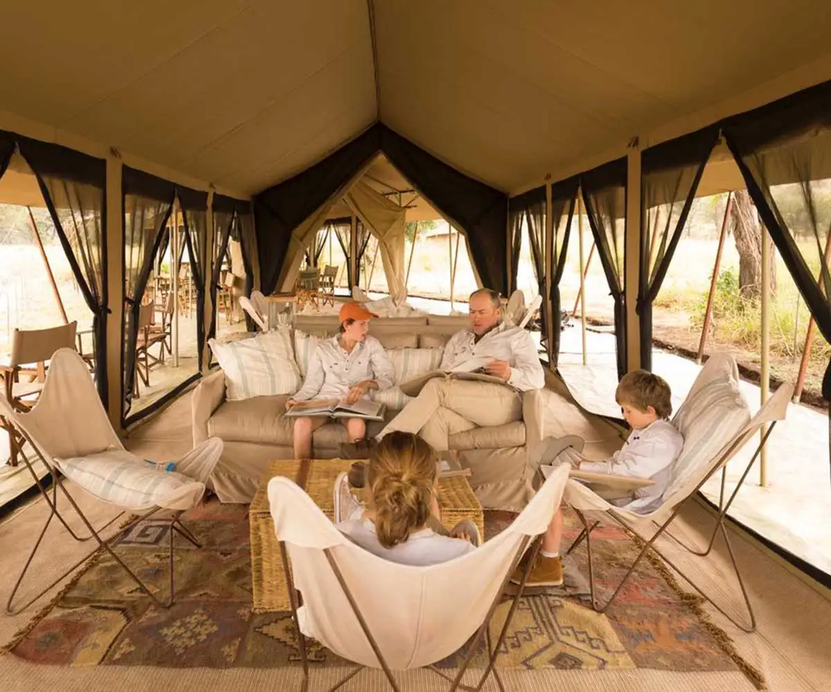 A happy family enjoying a luxury safari experience at a Serengeti lodge, arranged by JM Tours for a Tanzania Luxury Safari.