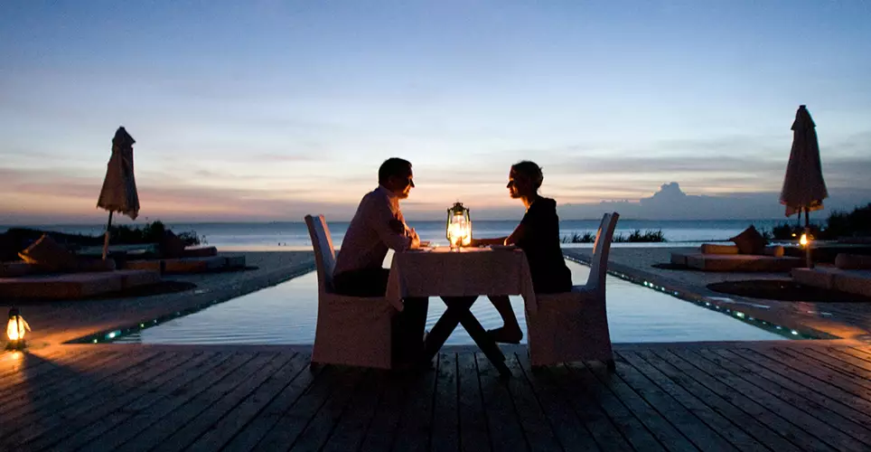 Honeymoon couples enjoying a romantic getaway on the stunning beaches of Zanzibar, courtesy of JM Tours' 7-Day Tanzania and Zanzibar Honeymoon safari.