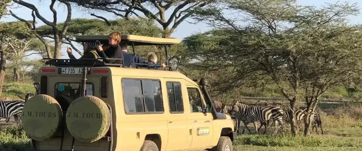 1 Day Safari At Arusha National Park. diverse wildlife, walking safari, and stunning landscapes.